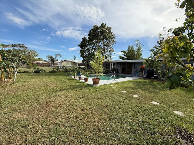 view of yard featuring a fenced in pool and a patio area