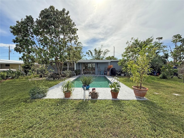 107 Dunn Dr NE, Port Charlotte, FL 33952 - back of house with a patio area, a lawn, and an outdoor pool