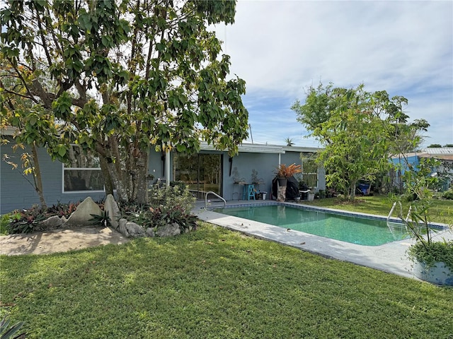 view of pool featuring a yard and a patio