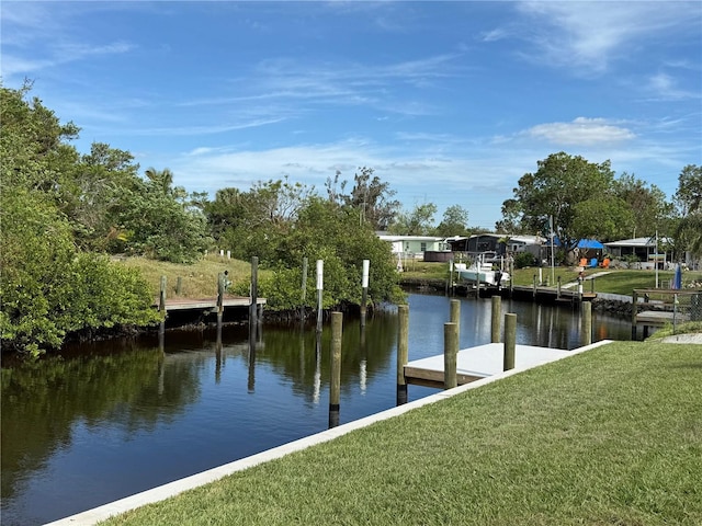 dock area featuring a lawn and a water view