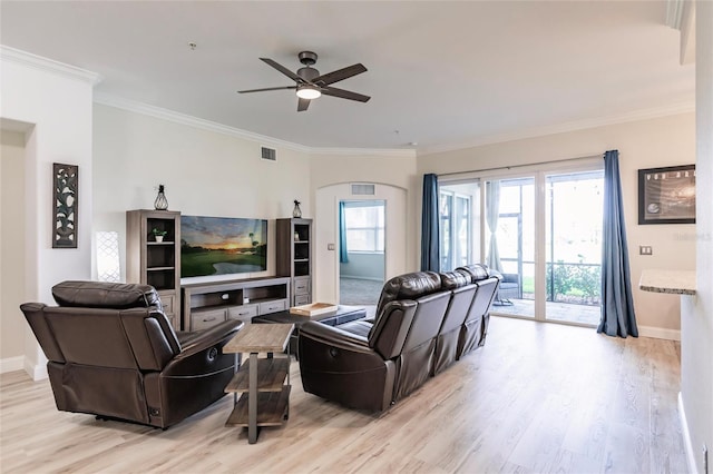 living room with ceiling fan, crown molding, and light hardwood / wood-style flooring