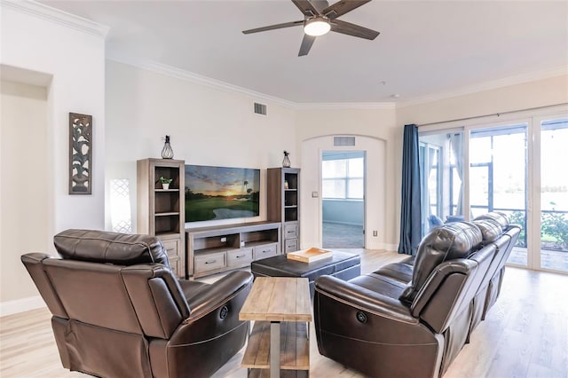 living room with crown molding, ceiling fan, and light wood-type flooring