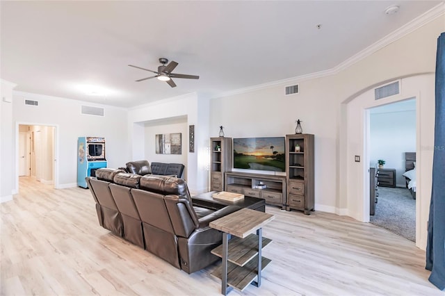 living room with light wood-type flooring, ceiling fan, and crown molding