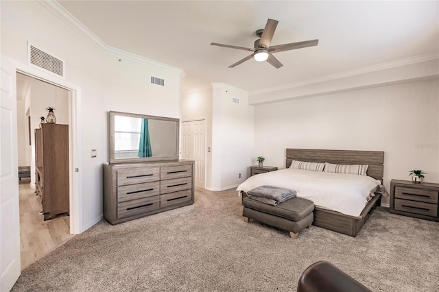 carpeted bedroom featuring ceiling fan, crown molding, and a closet