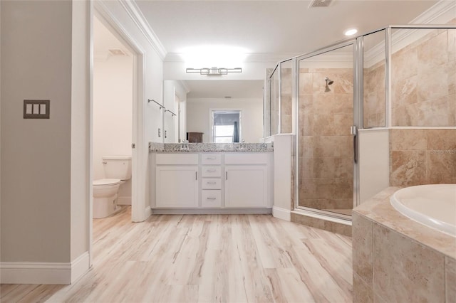 full bathroom featuring vanity, crown molding, hardwood / wood-style flooring, shower with separate bathtub, and toilet