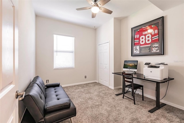 carpeted office space with ceiling fan