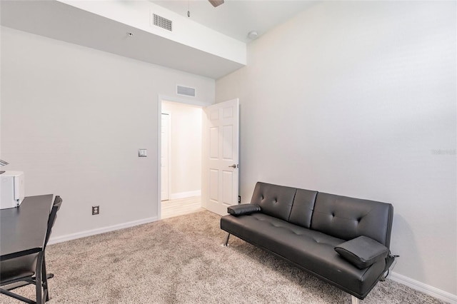 sitting room with light colored carpet and ceiling fan