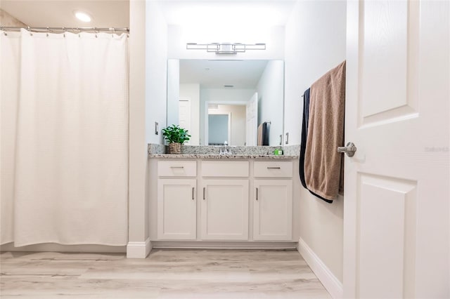 bathroom featuring hardwood / wood-style floors and vanity