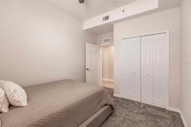 carpeted bedroom with ceiling fan and a closet