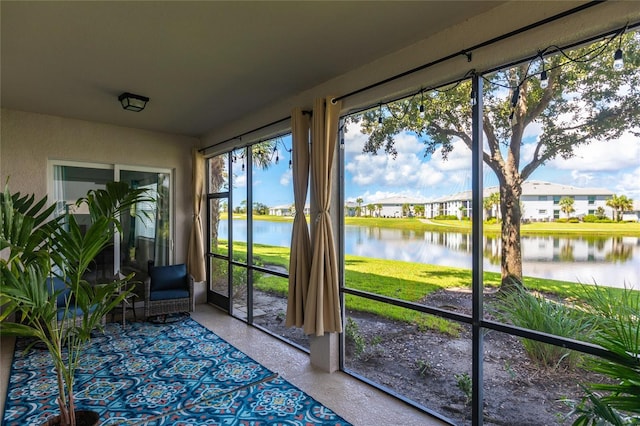 unfurnished sunroom featuring a water view