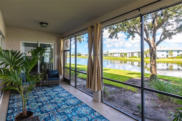 unfurnished sunroom with a water view