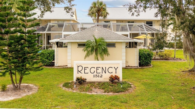 community sign featuring a yard