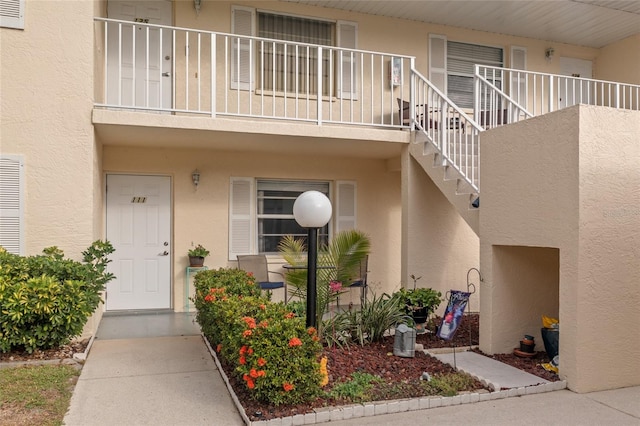 view of exterior entry featuring a balcony