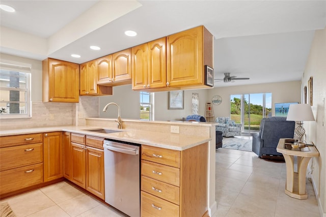 kitchen featuring ceiling fan, dishwasher, sink, kitchen peninsula, and light tile patterned flooring