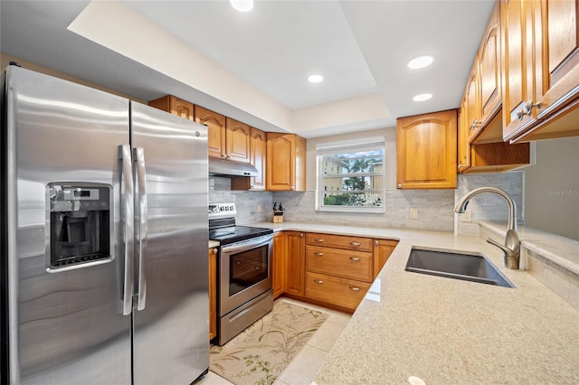 kitchen featuring light tile patterned flooring, sink, stainless steel appliances, and tasteful backsplash