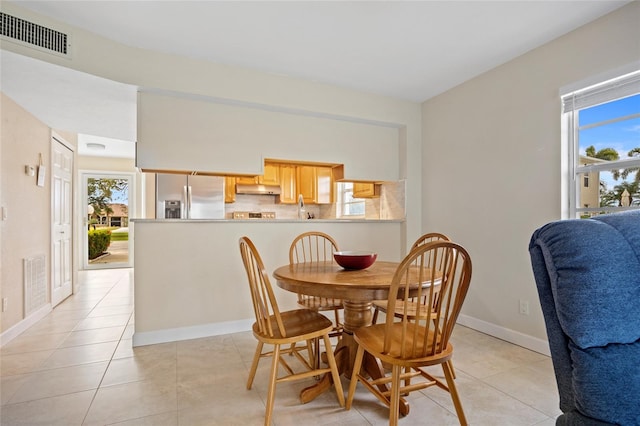 dining space with plenty of natural light and light tile patterned floors