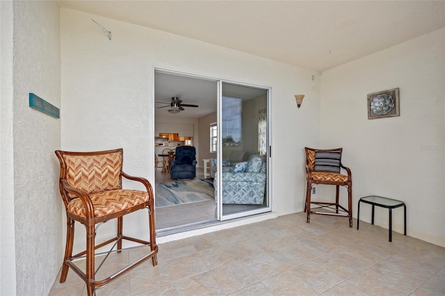 sitting room with ceiling fan