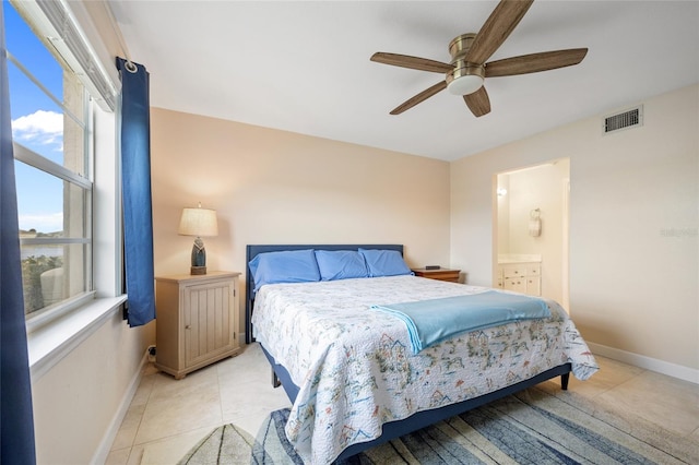 bedroom with ensuite bath, ceiling fan, and light tile patterned floors