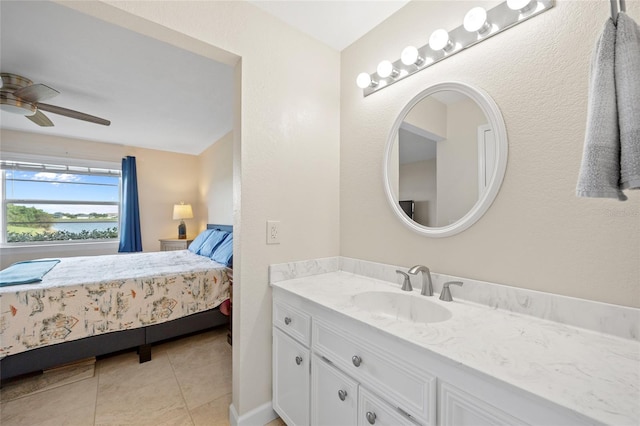 bathroom featuring tile patterned flooring, ceiling fan, and vanity