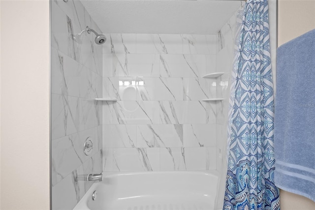 bathroom featuring shower / bath combination with curtain and a textured ceiling