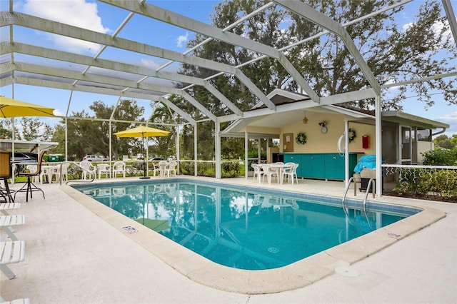 view of swimming pool featuring glass enclosure and a patio