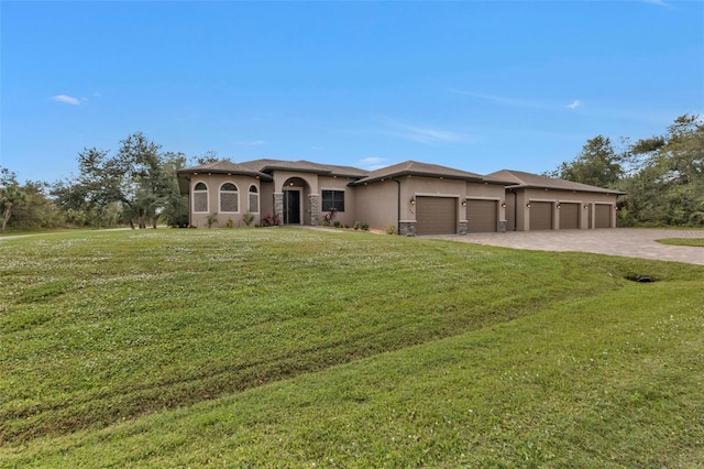 view of front of home featuring a front yard and a garage