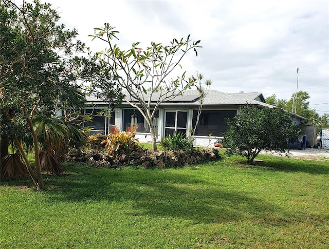 exterior space featuring a lawn and solar panels