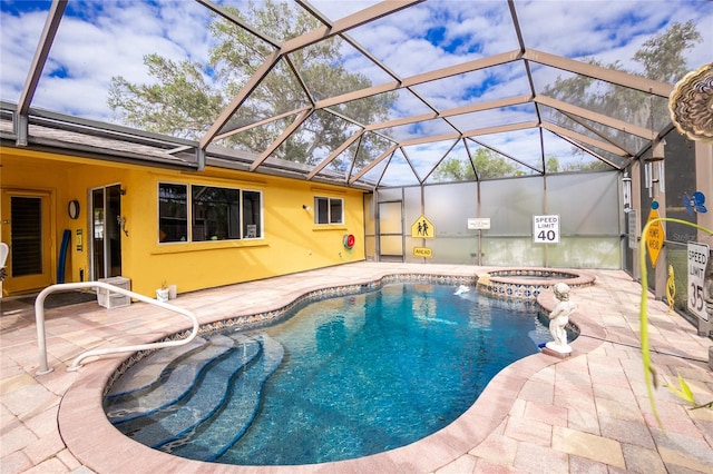 view of swimming pool with glass enclosure, an in ground hot tub, and a patio