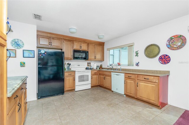 kitchen with sink, light tile patterned flooring, and black appliances