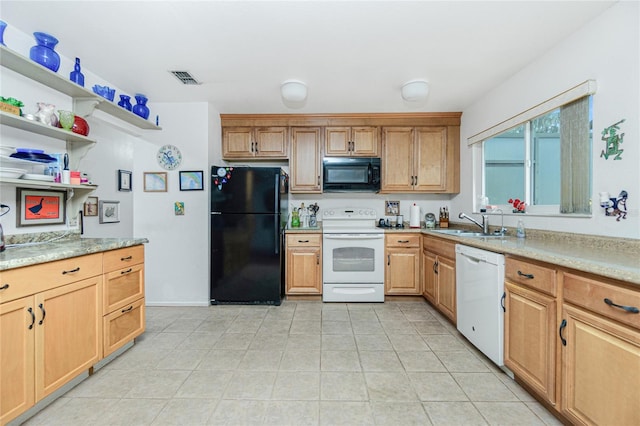 kitchen featuring sink, light tile patterned floors, and black appliances