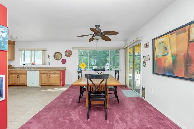 tiled dining area with sink, plenty of natural light, and ceiling fan