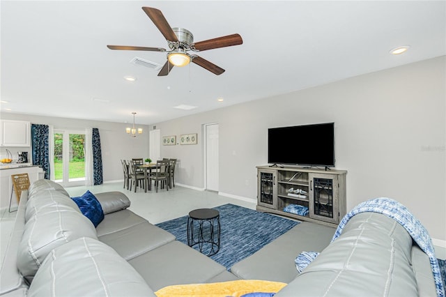 living room with visible vents, recessed lighting, baseboards, and ceiling fan with notable chandelier