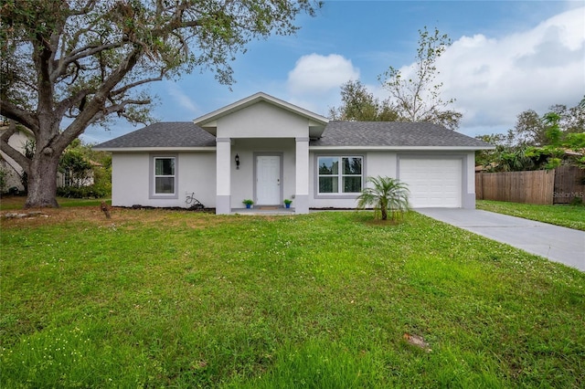 ranch-style home featuring fence, an attached garage, a front lawn, stucco siding, and driveway