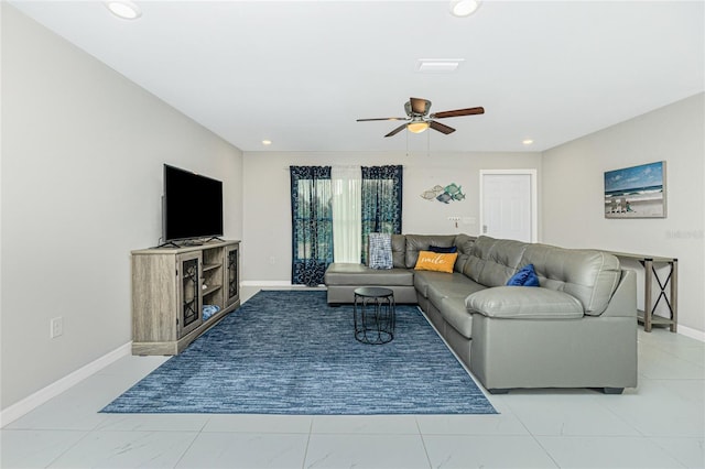 living area with recessed lighting, a ceiling fan, and baseboards