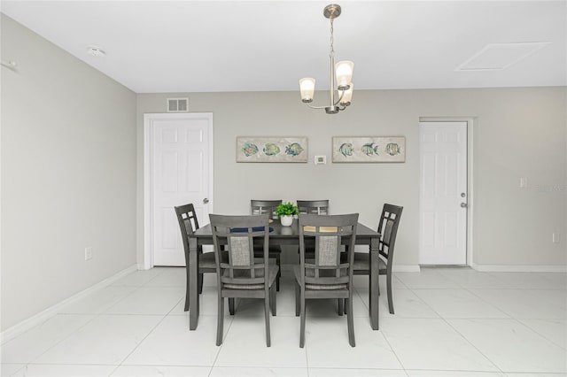 dining area featuring baseboards, a chandelier, and visible vents