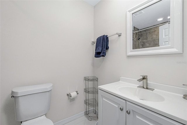 full bath featuring vanity, baseboards, and toilet