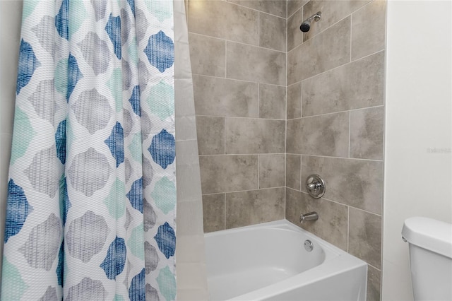 bathroom with toilet and shower / bath combination with curtain