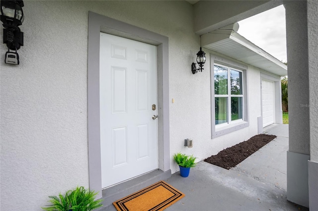 view of exterior entry with stucco siding