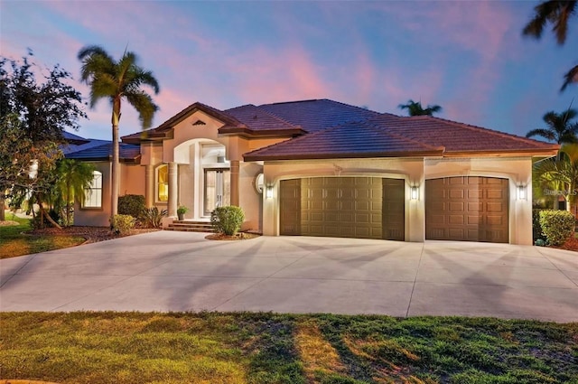 mediterranean / spanish-style home with a garage