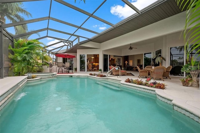 view of pool with ceiling fan, a patio area, a lanai, and an in ground hot tub