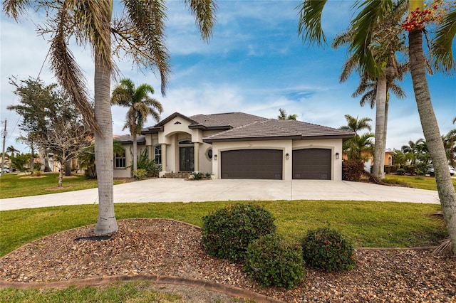 mediterranean / spanish-style house with a garage and a front yard