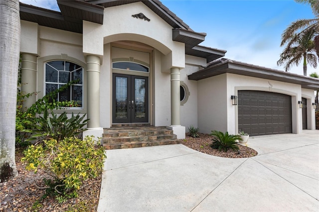 doorway to property featuring a garage and french doors