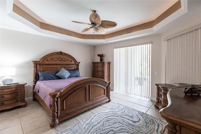 bedroom with ceiling fan, access to exterior, a raised ceiling, and light tile patterned floors