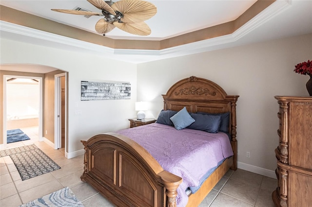 bedroom with light tile patterned flooring, crown molding, ceiling fan, and a tray ceiling