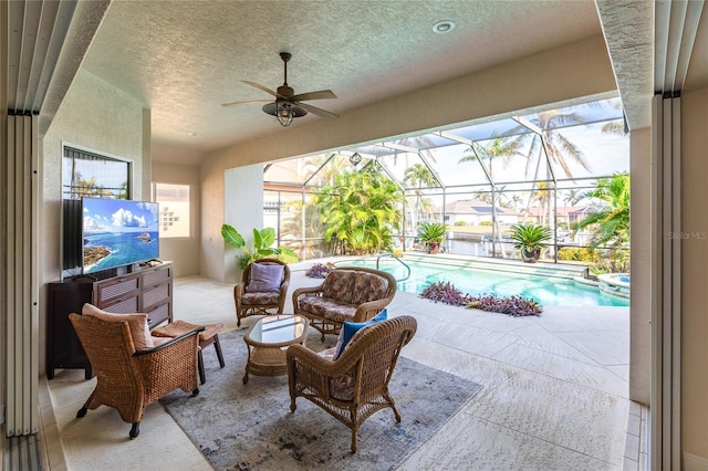 view of patio / terrace with a lanai, outdoor lounge area, and ceiling fan