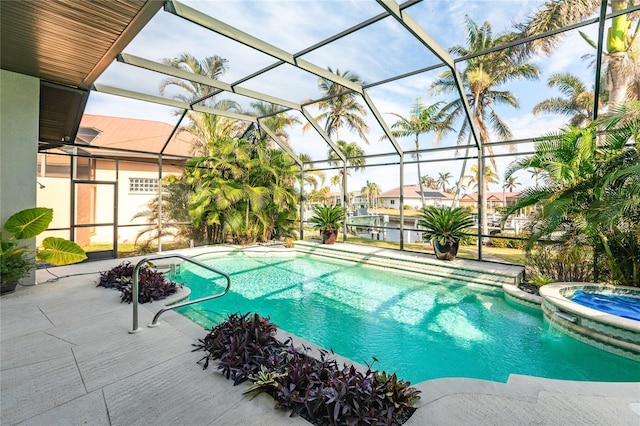 view of pool featuring an in ground hot tub, a lanai, and a patio