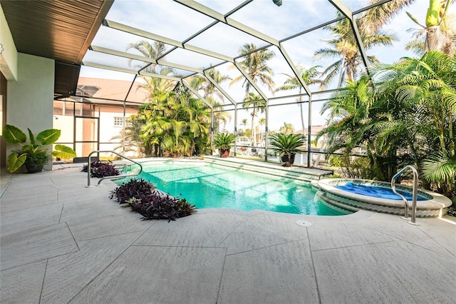 view of swimming pool featuring an in ground hot tub, a patio, and glass enclosure