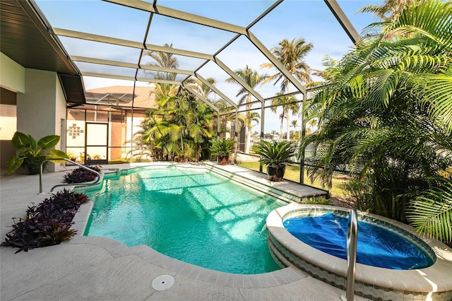 view of swimming pool with a lanai, a patio area, and an in ground hot tub