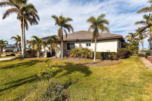 back of house with a lawn