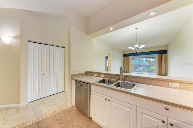 kitchen featuring white cabinetry, dishwasher, sink, hanging light fixtures, and a chandelier